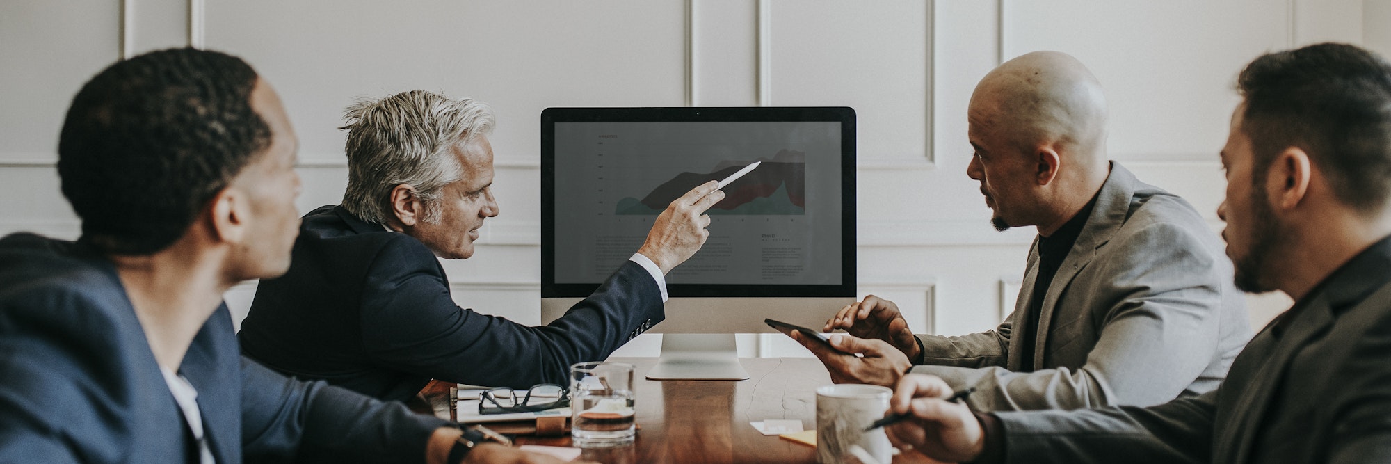 Board of director discussing business growth in computer